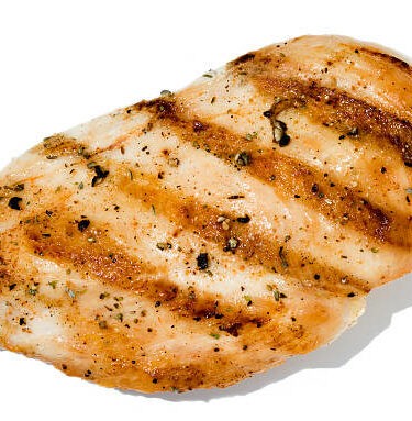 Broiled seasoned Chicken isolated on white.